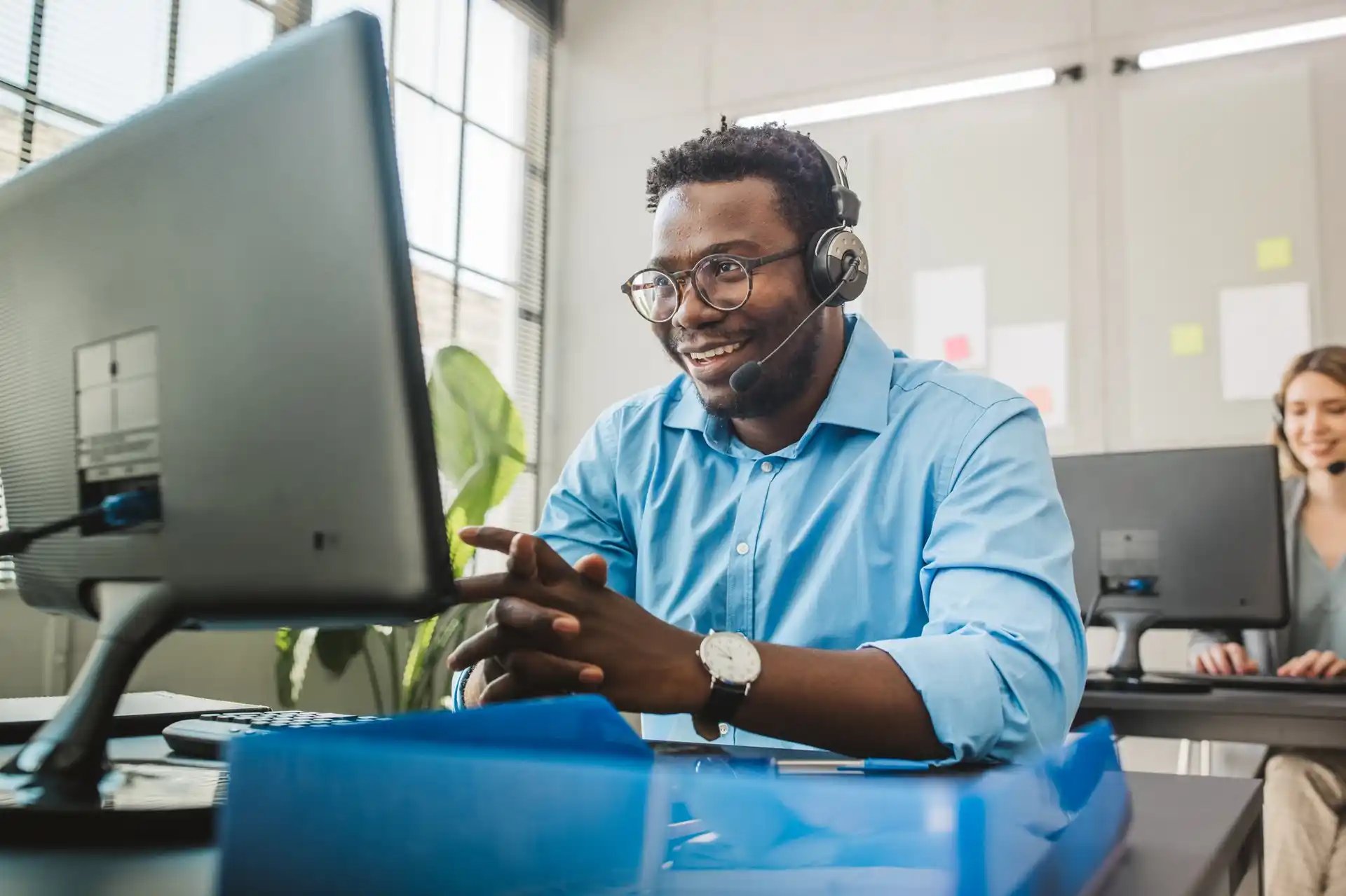 customer support rep on headset in office